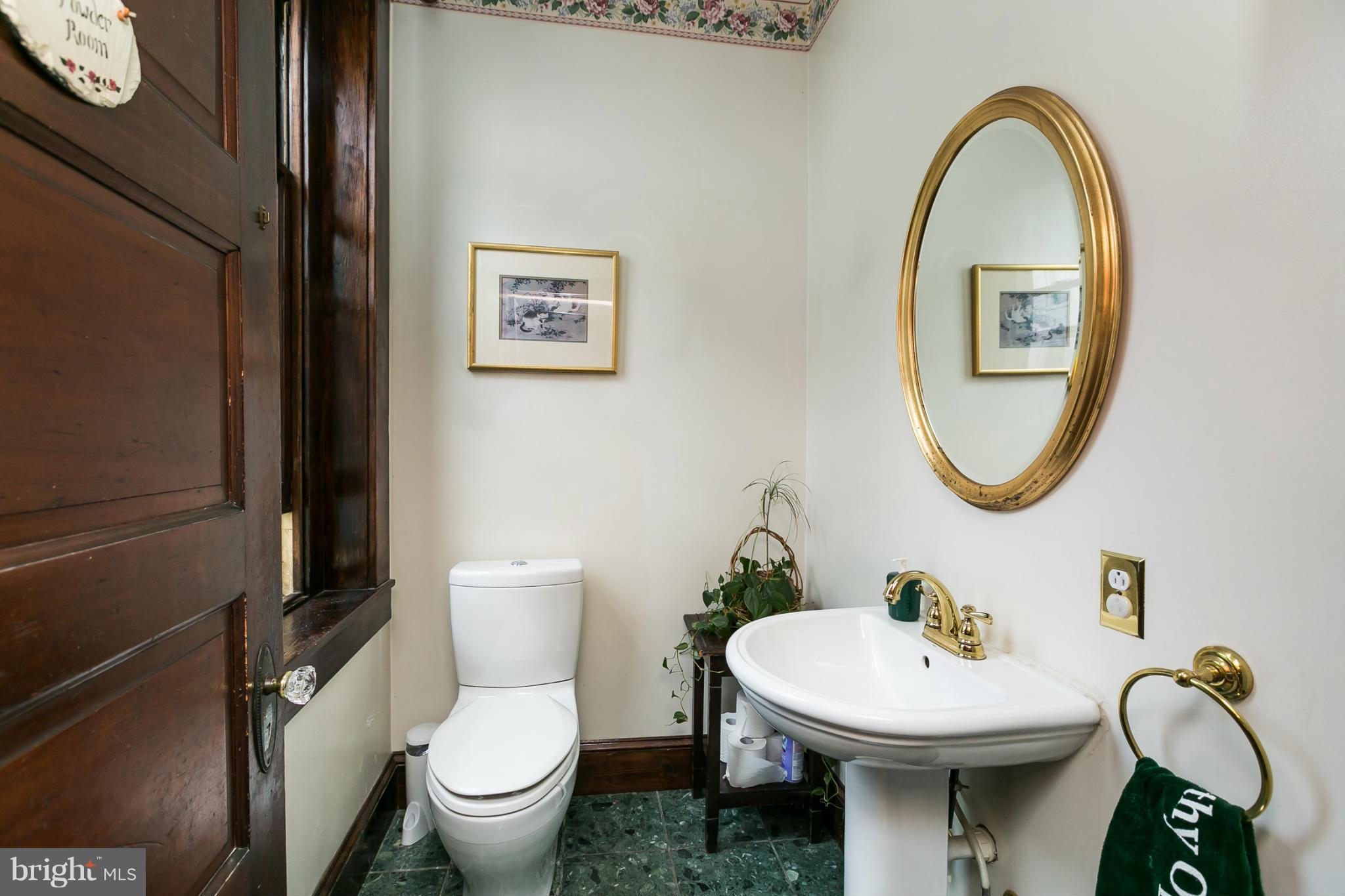 4015 Roland Avenue Baltimore, MD 21211 - Photo 13 of 30 a bathroom with a toilet and a sink