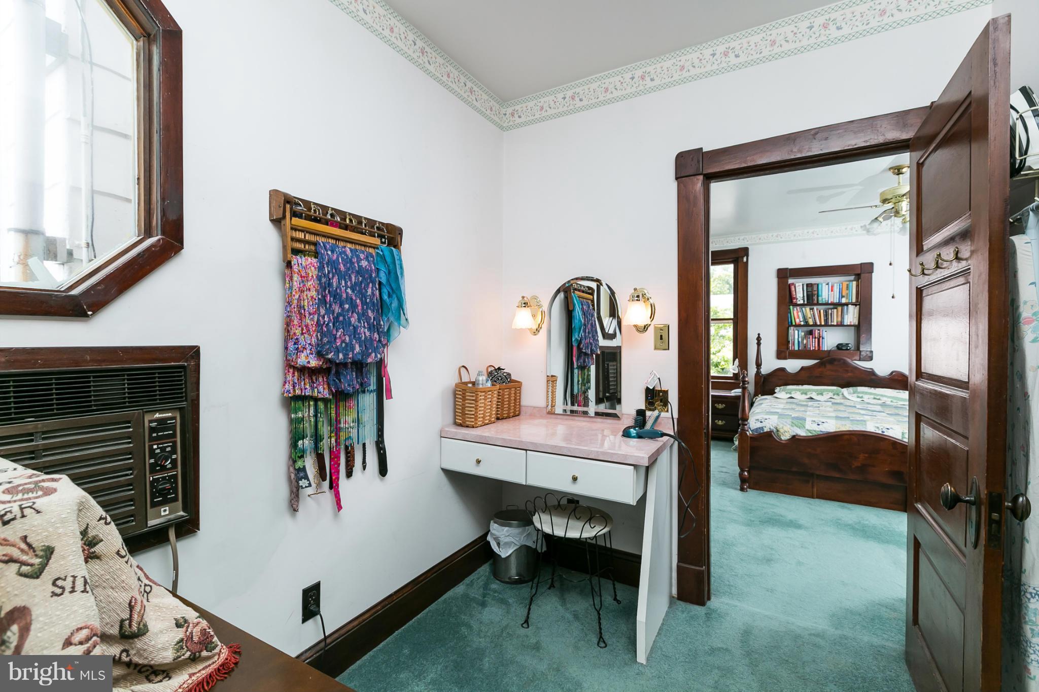 4015 Roland Avenue Baltimore, MD 21211 - Photo 16 of 30 a bed room with a bed and a mirror