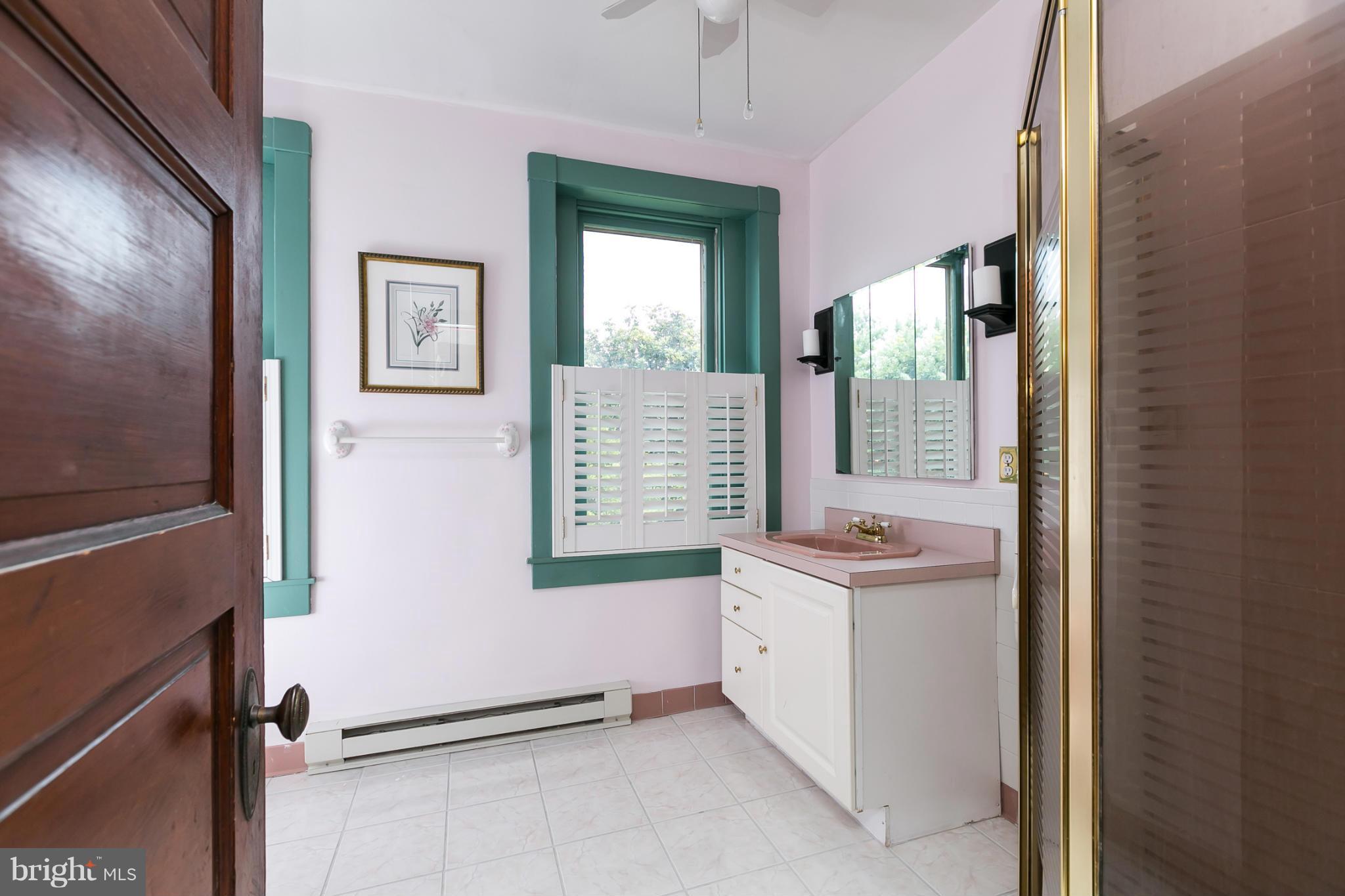 4015 Roland Avenue Baltimore, MD 21211 - Photo 17 of 30 a view of an entryway with a sink and a mirror