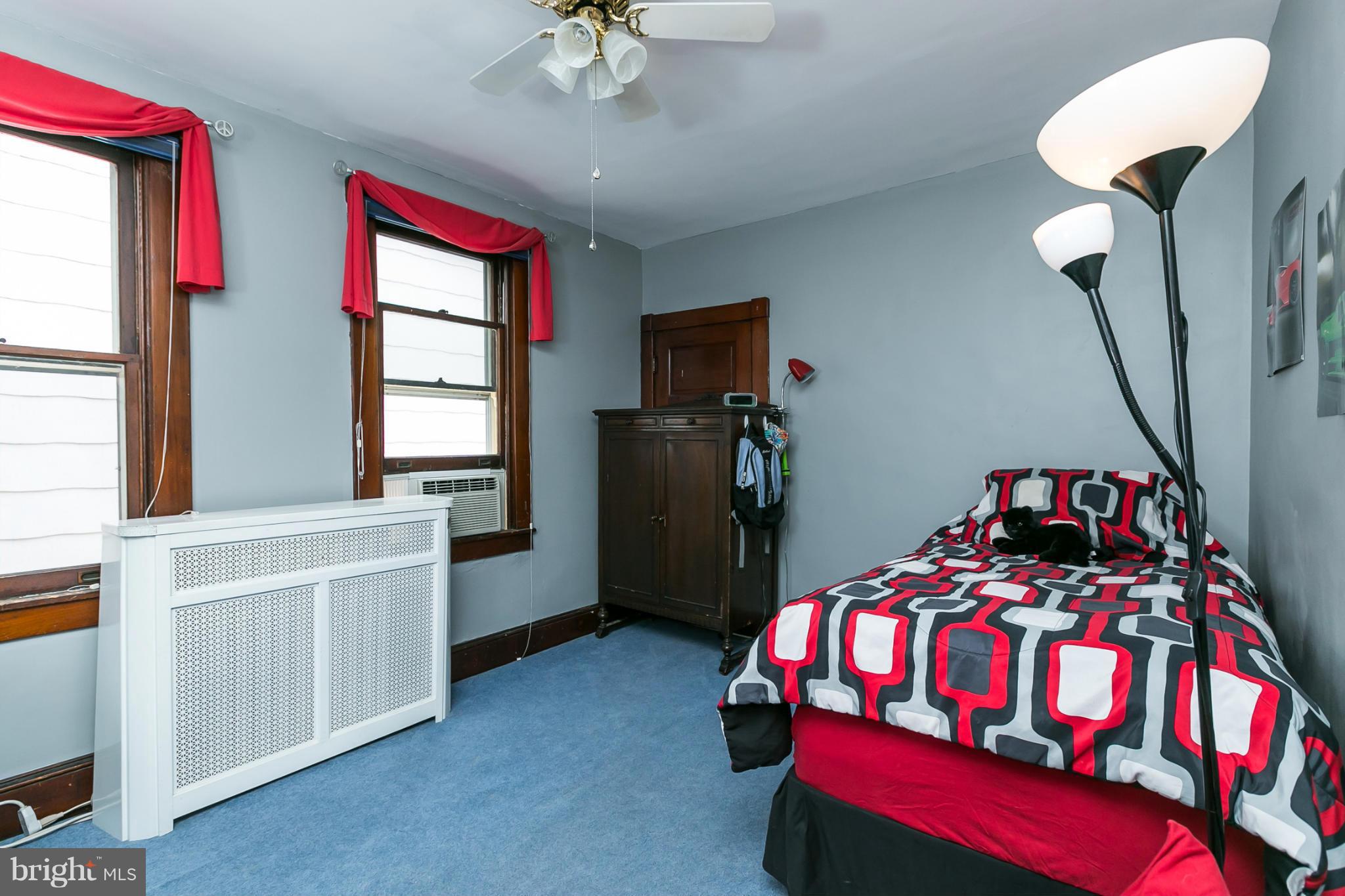 4015 Roland Avenue Baltimore, MD 21211 - Photo 19 of 30 a bedroom with a bed and a chandelier