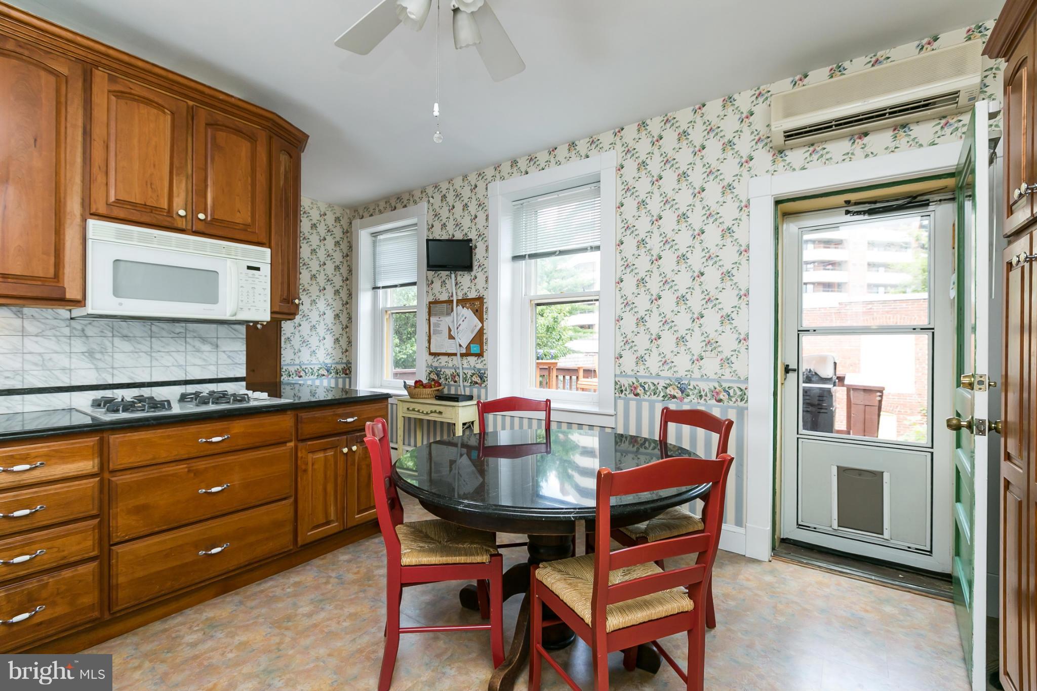 4015 Roland Avenue Baltimore, MD 21211 - Photo 10 of 30 a dining room with a wooden table and chairs