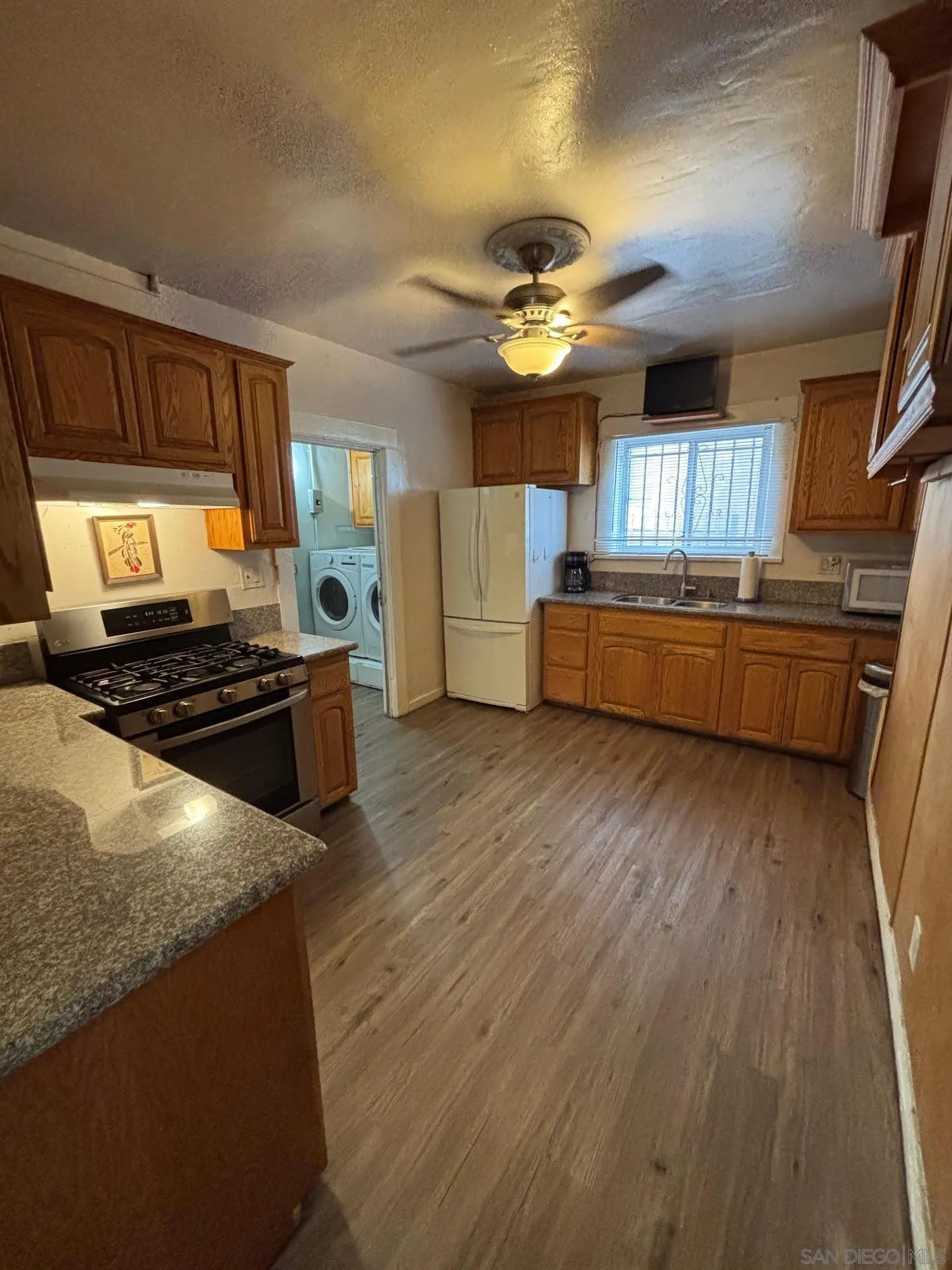 2925 Franklin Avenue San Diego, CA 92113 - Photo 12 of 36 a kitchen with stainless steel appliances granite countertop a stove and a refrigerator