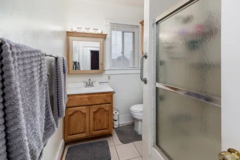 a bathroom with a granite countertop sink toilet and shower