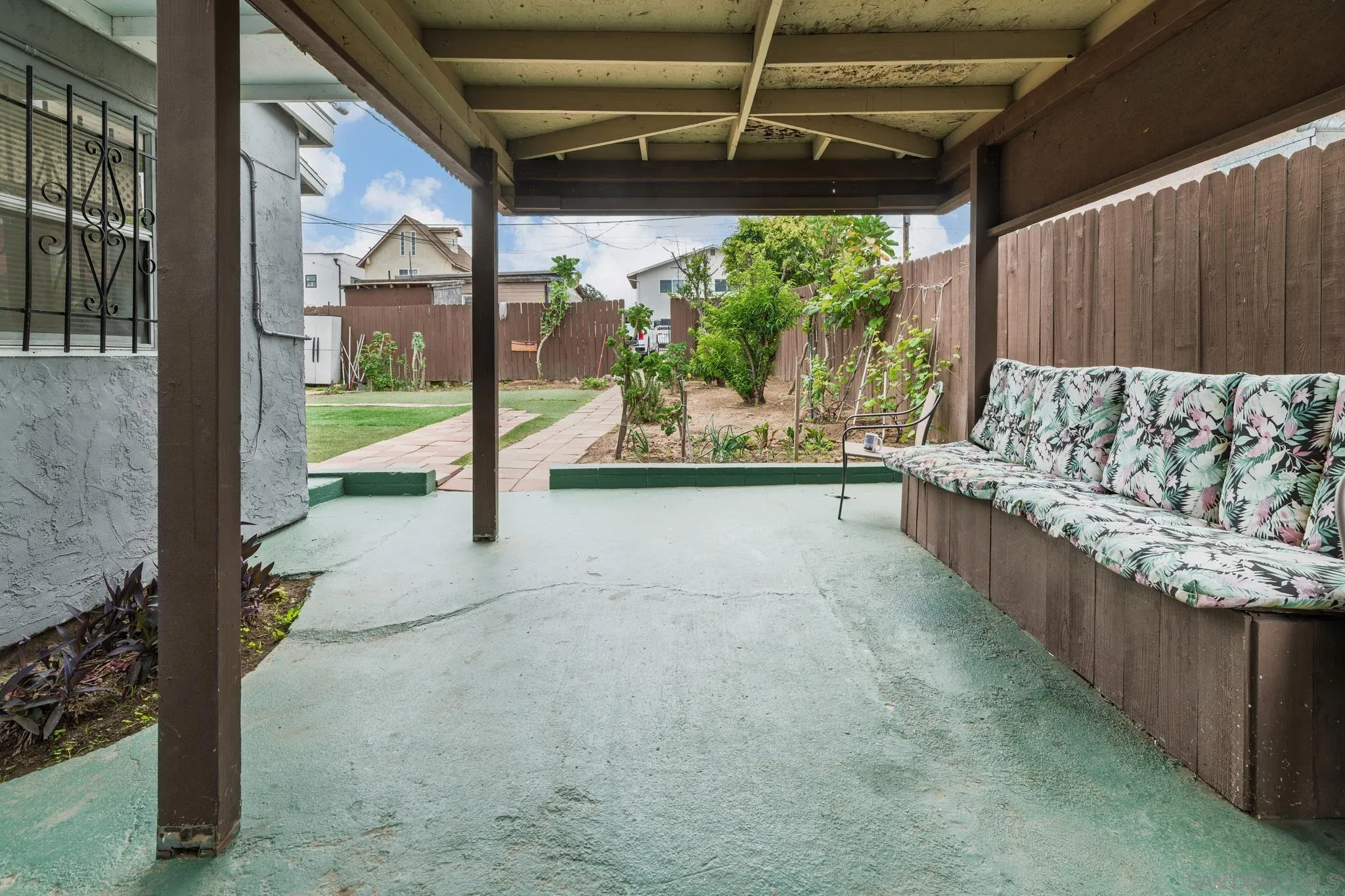 2925 Franklin Avenue San Diego, CA 92113 - Photo 19 of 36 a view of a porch with furniture and floor to ceiling window