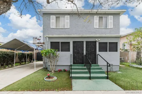 a view of house with a yard and sitting area