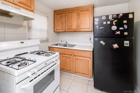 a kitchen with a stove and a refrigerator