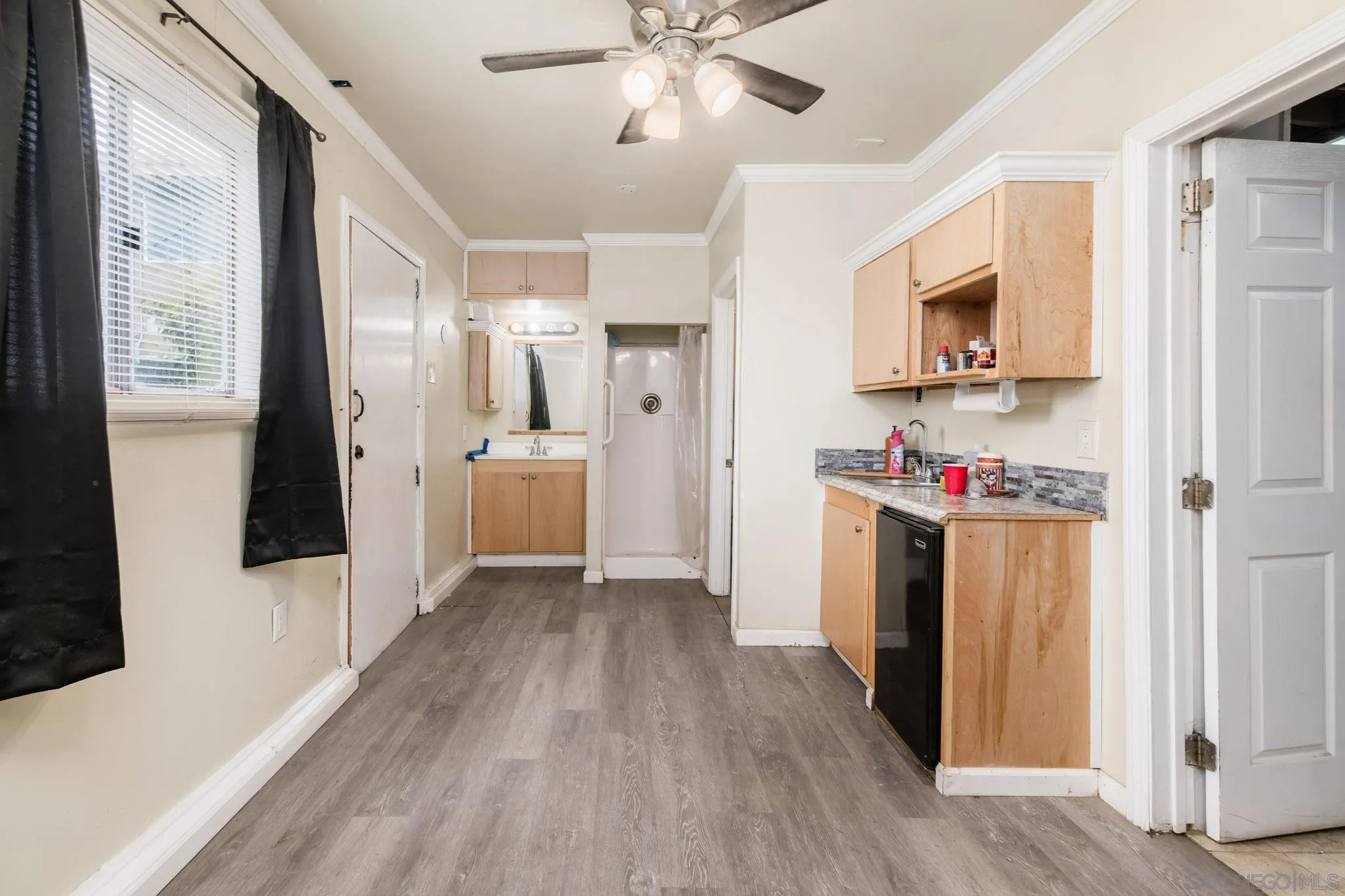 2925 Franklin Avenue San Diego, CA 92113 - Photo 33 of 36 a view of a kitchen with refrigerator and wooden floor
