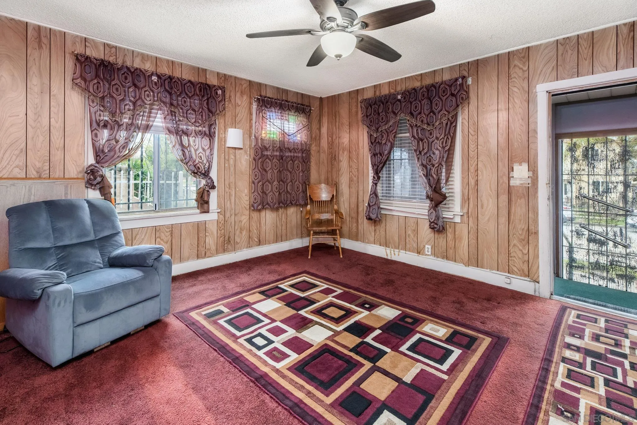 2925 Franklin Avenue San Diego, CA 92113 - Photo 6 of 36 a living room with a couch and a rug