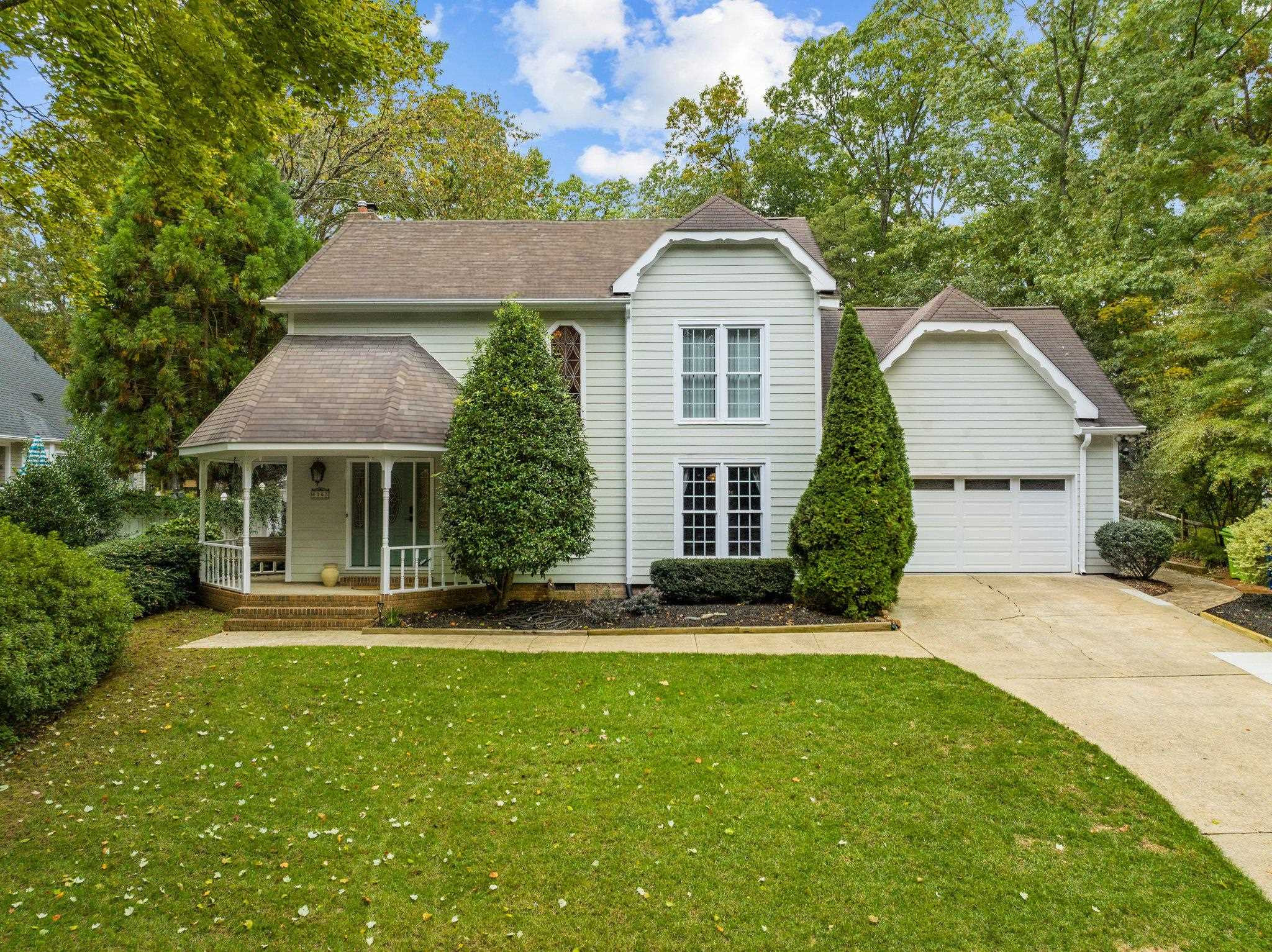 6305 Rushingbrook Drive Raleigh, NC 27612 - Photo 1 of 48 a front view of a house with a yard and garage