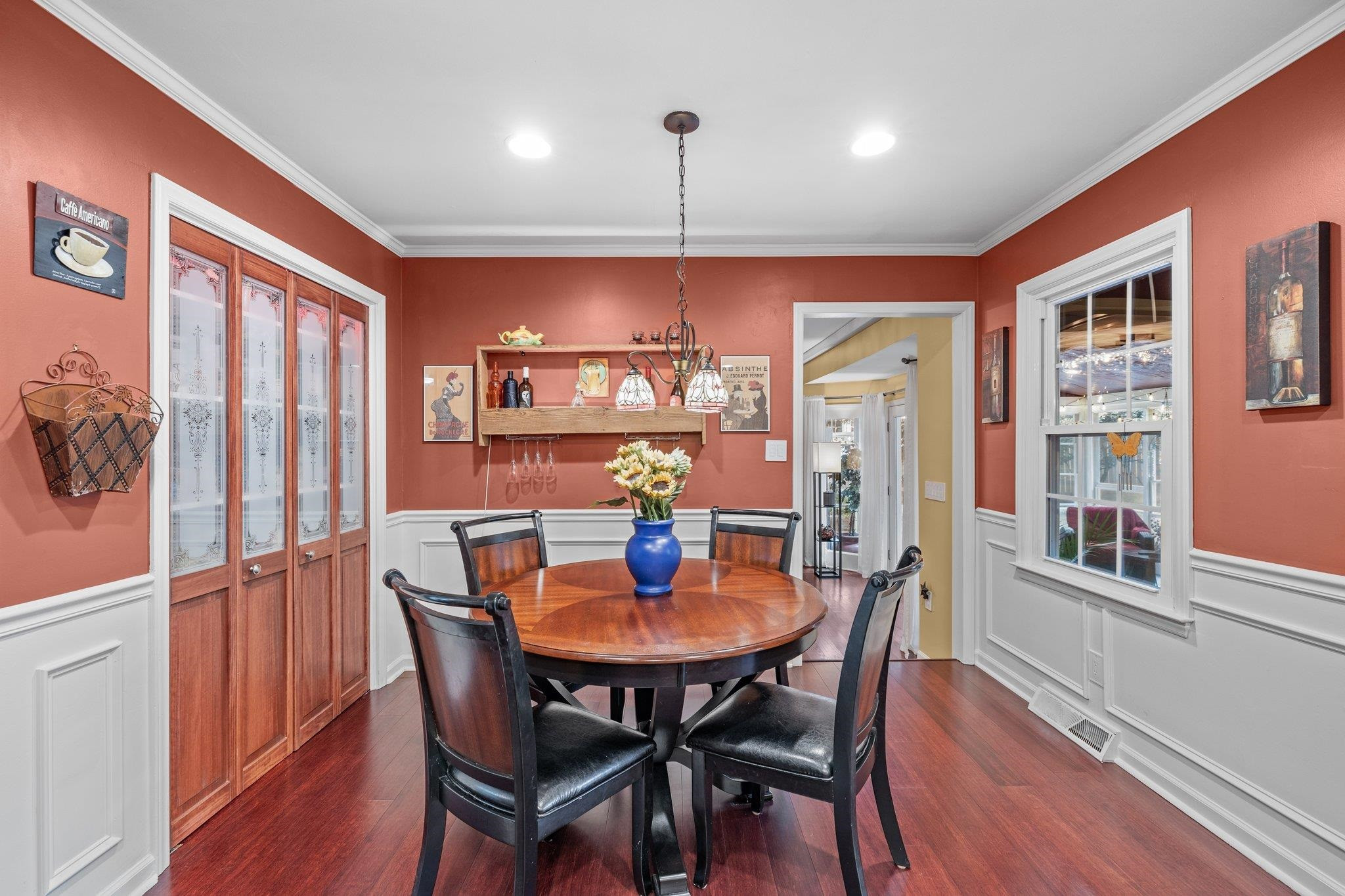6305 Rushingbrook Drive Raleigh, NC 27612 - Photo 16 of 48 a dining room with furniture a chandelier and wooden floor