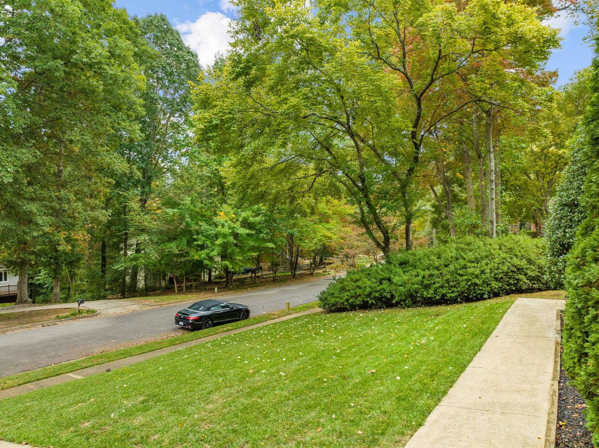 6305 Rushingbrook Drive Raleigh, NC 27612 - Photo 3 of 48 a view of backyard with large trees and plants