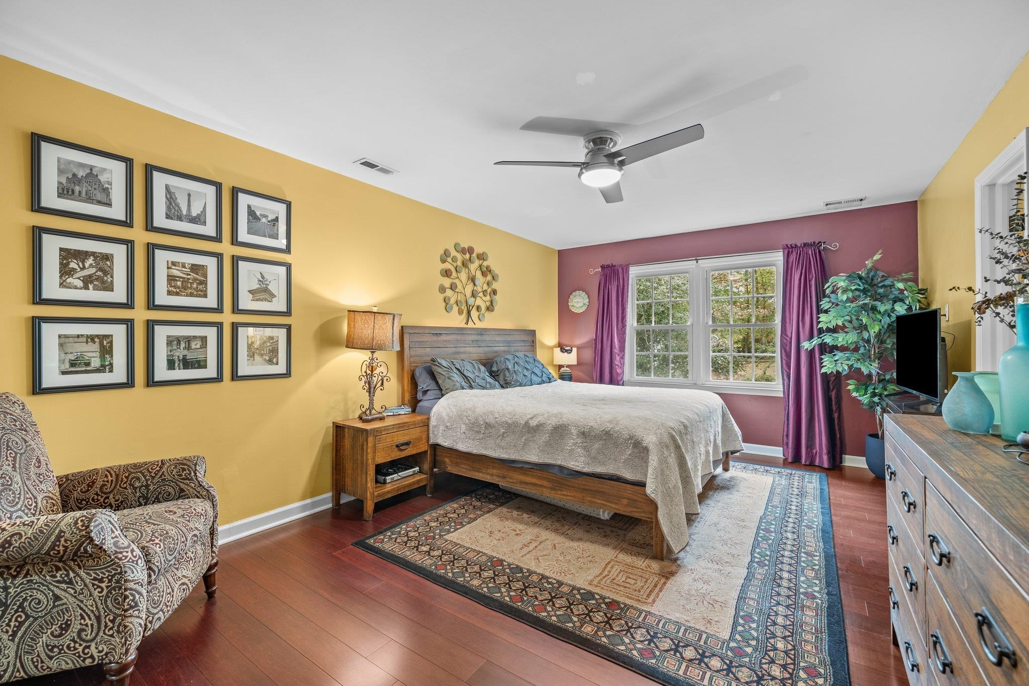 6305 Rushingbrook Drive Raleigh, NC 27612 - Photo 34 of 48 a bedroom with a bed couch and a large window
