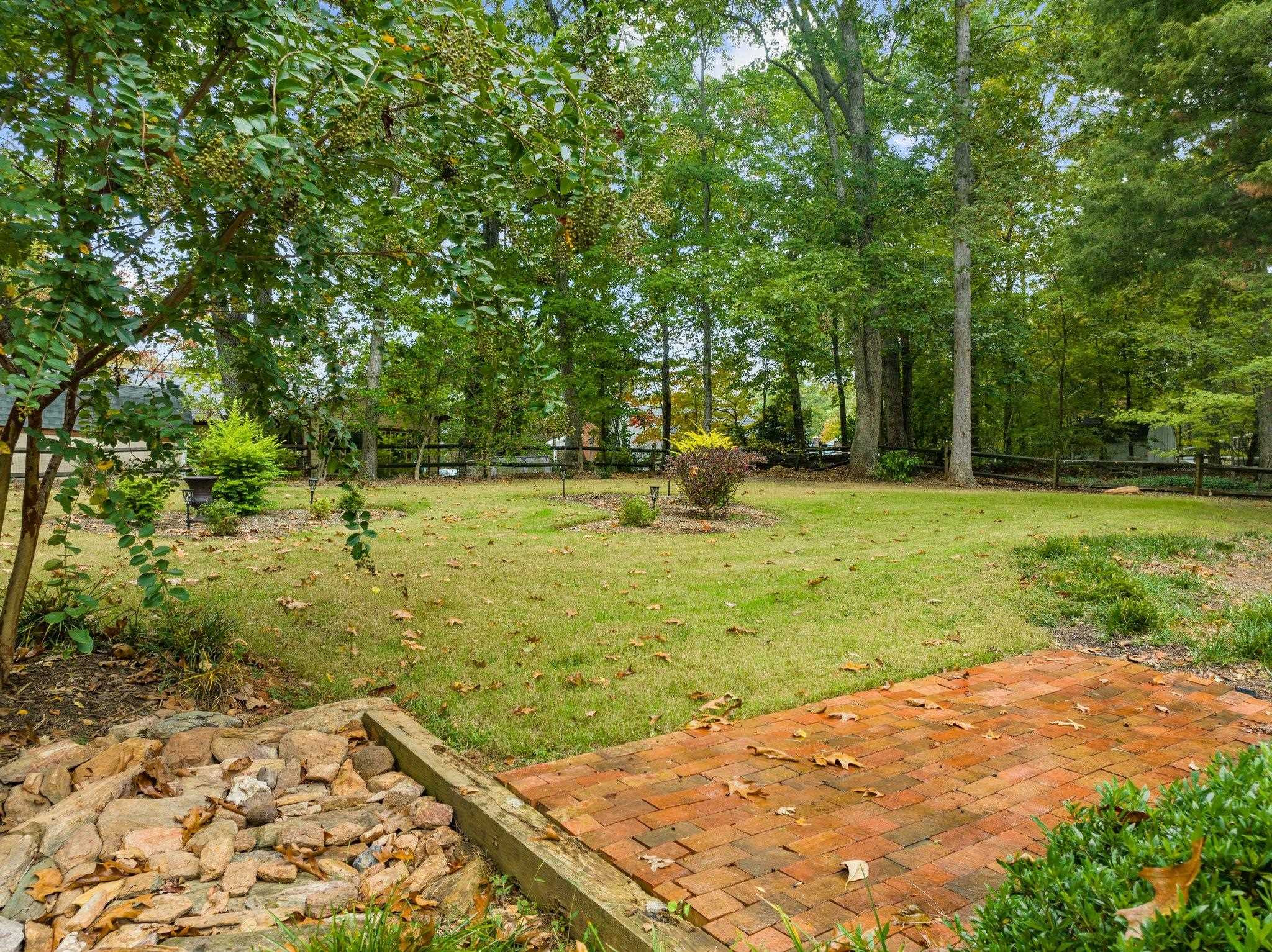 6305 Rushingbrook Drive Raleigh, NC 27612 - Photo 40 of 48 a view of a backyard with large trees