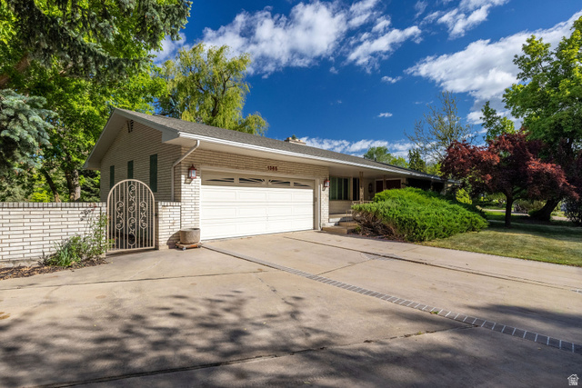 1365 Sumac Drive Logan, UT 84321 - Photo 62 of 66 Single-story residence featuring light-colored brick exterior, attached two-car garage, and a concrete driveway