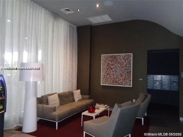 a living room with furniture a lamp and a window