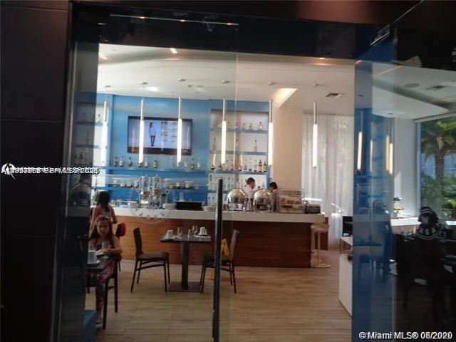 a living room with stainless steel appliances kitchen island granite countertop furniture and a large window