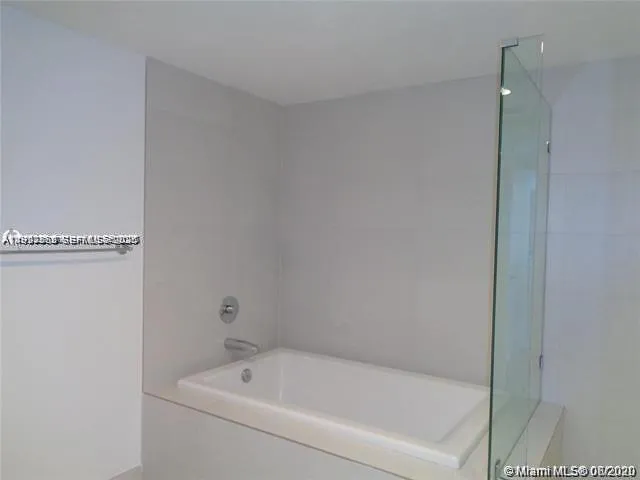 a white bath tub sitting next to a white sink