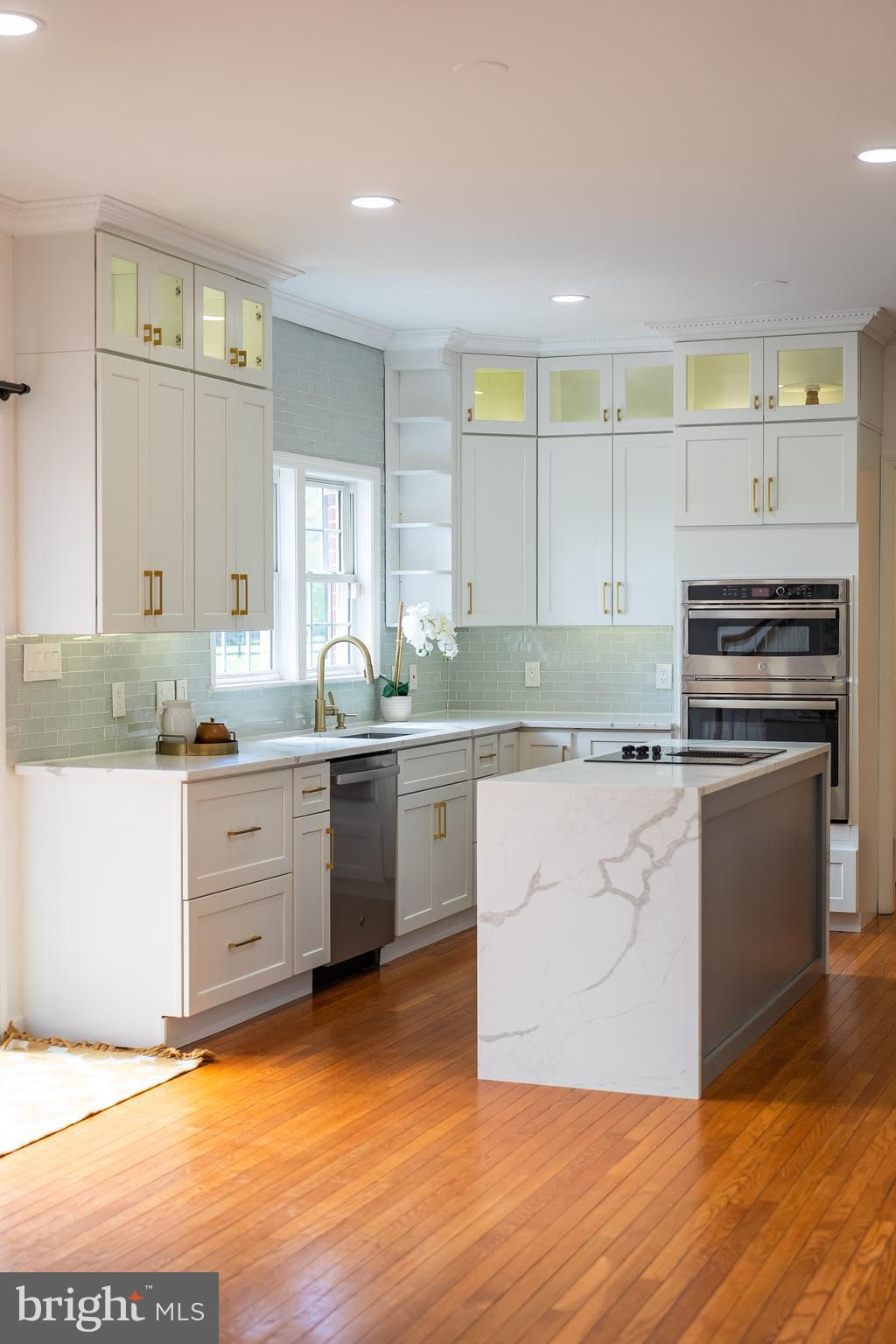 42827 Spinks Ferry Road Leesburg, VA 20176 - Photo 19 of 71 a kitchen with granite countertop a sink cabinets stainless steel appliances and a window
