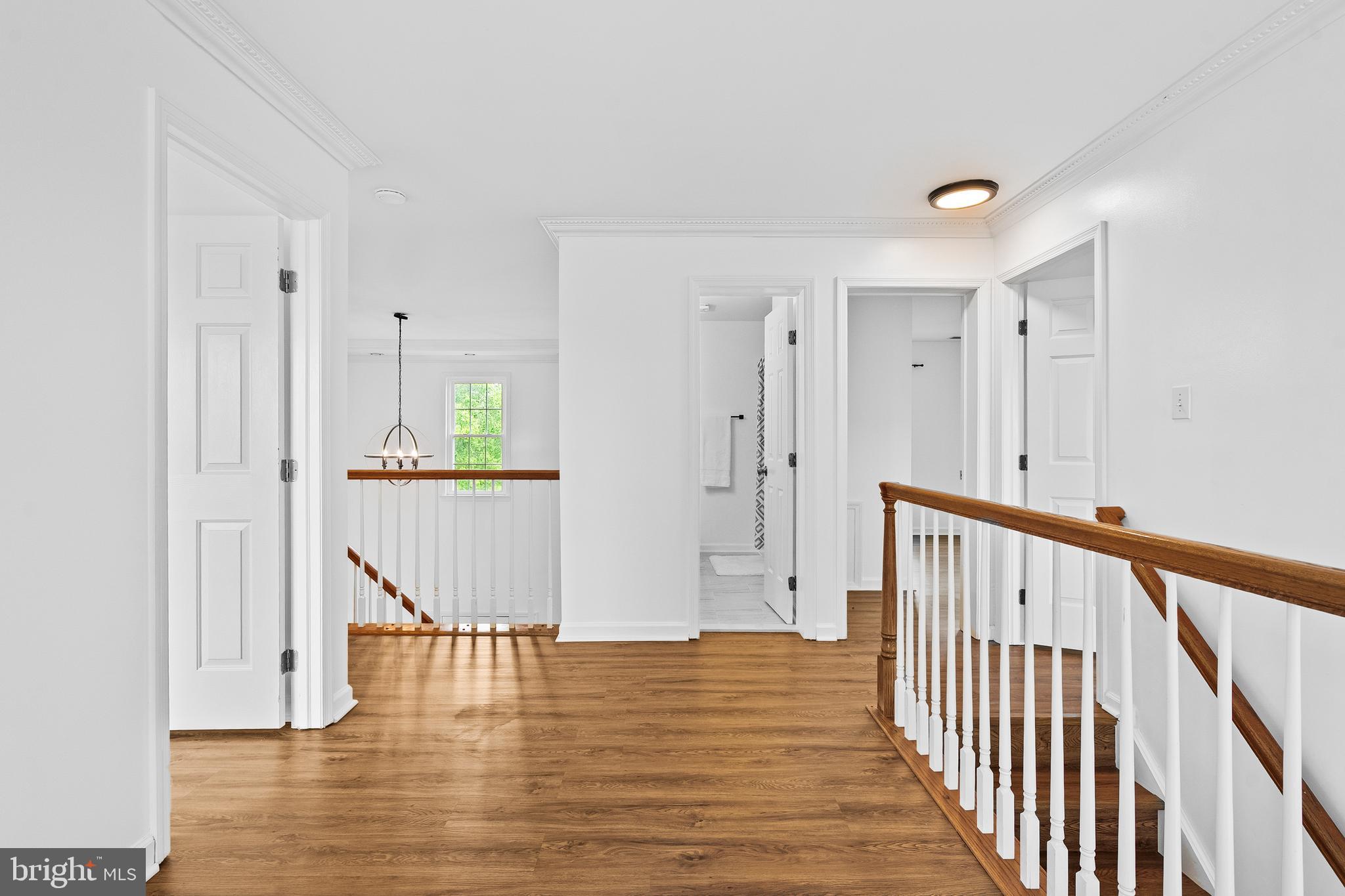 42827 Spinks Ferry Road Leesburg, VA 20176 - Photo 30 of 71 a view of a hallway with wooden floor and staircase