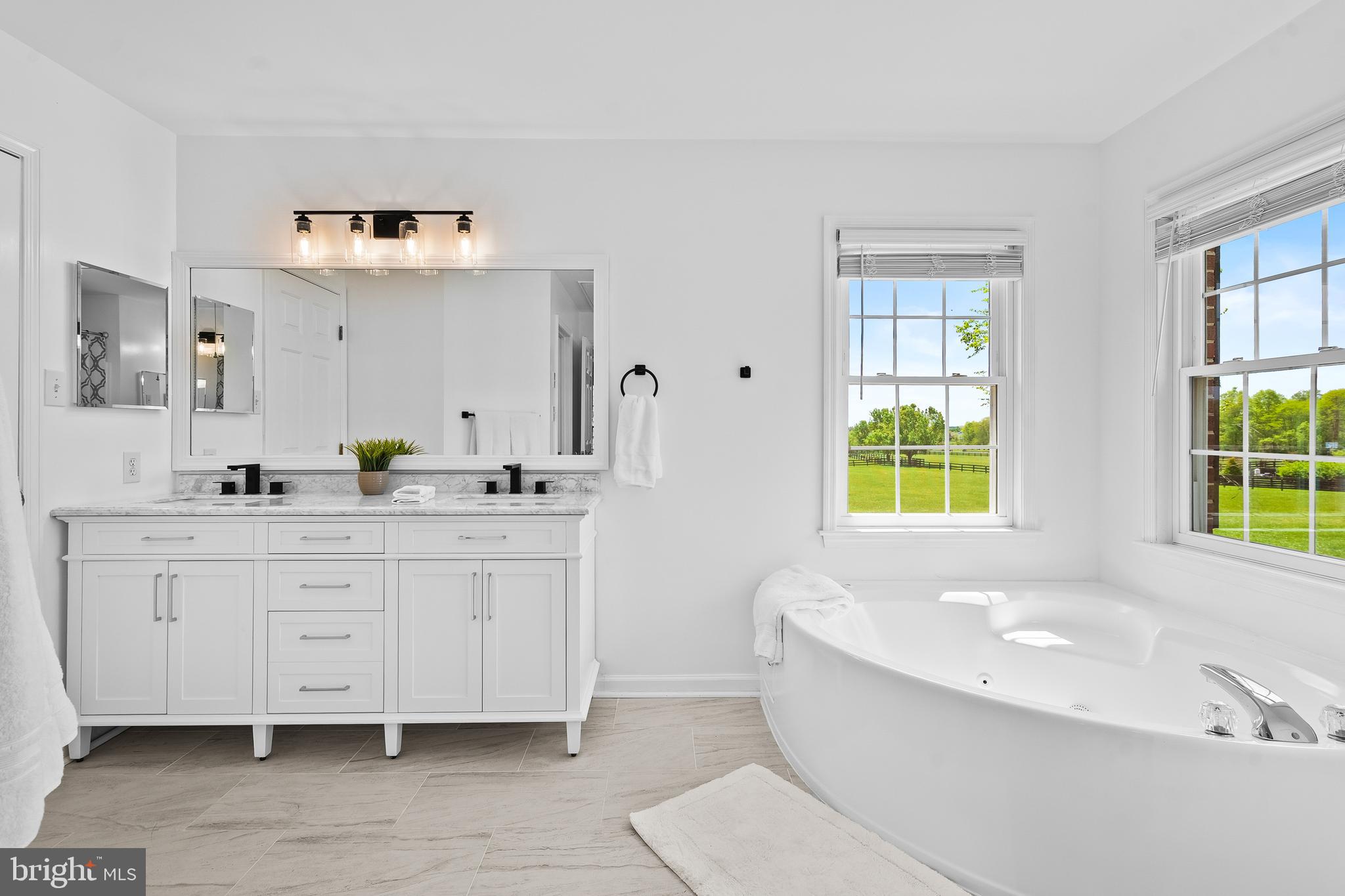 42827 Spinks Ferry Road Leesburg, VA 20176 - Photo 34 of 71 a spacious bathroom with double vanity sink a bathtub and window