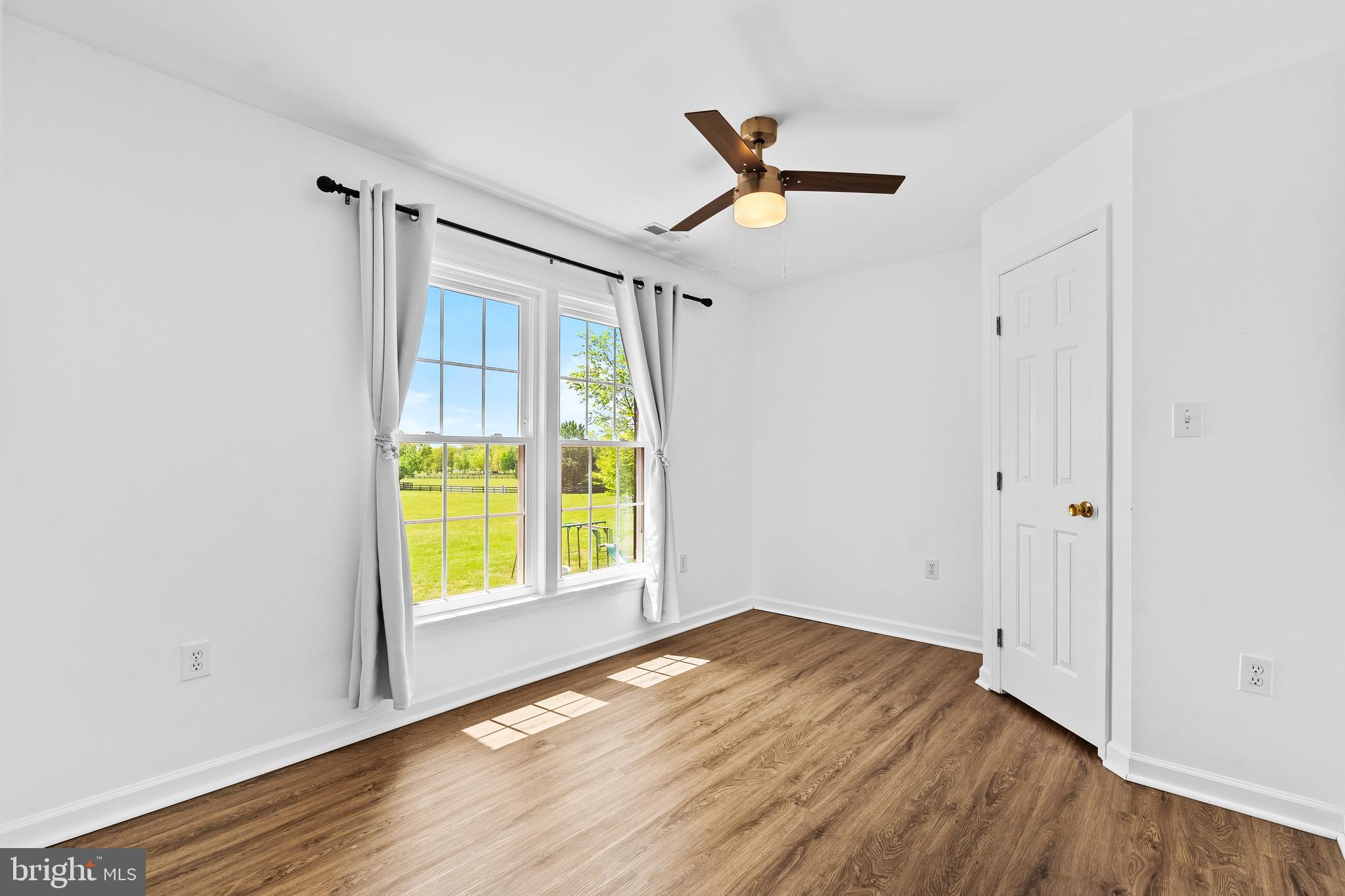 42827 Spinks Ferry Road Leesburg, VA 20176 - Photo 43 of 71 a view of empty room with wooden floor and fan