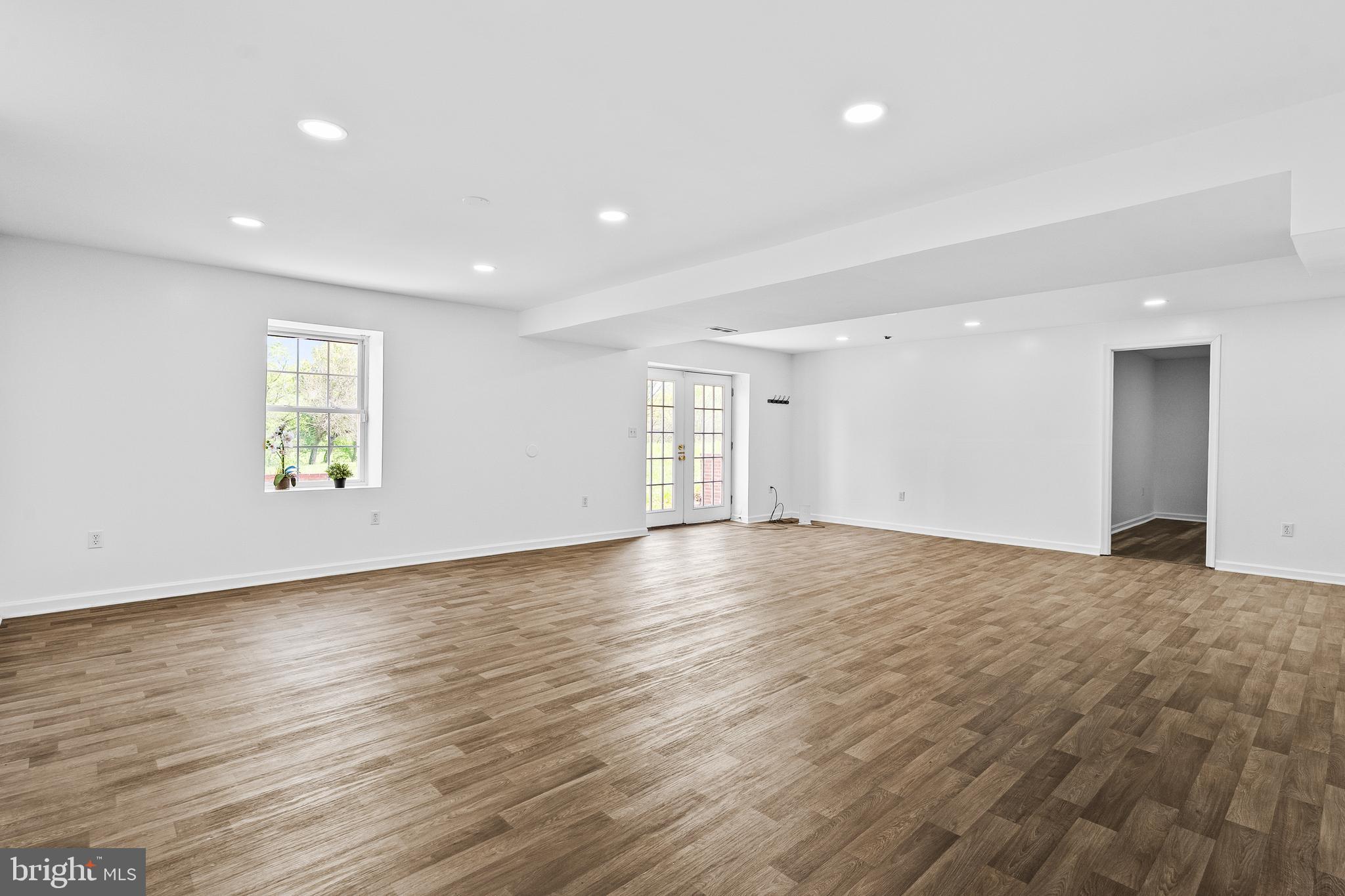 42827 Spinks Ferry Road Leesburg, VA 20176 - Photo 45 of 71 a view of an empty room with wooden floor and a window