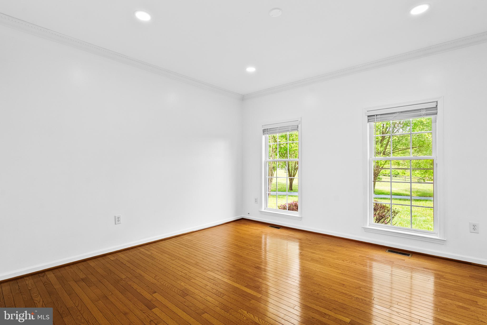 42827 Spinks Ferry Road Leesburg, VA 20176 - Photo 7 of 71 an empty room with wooden floor and windows
