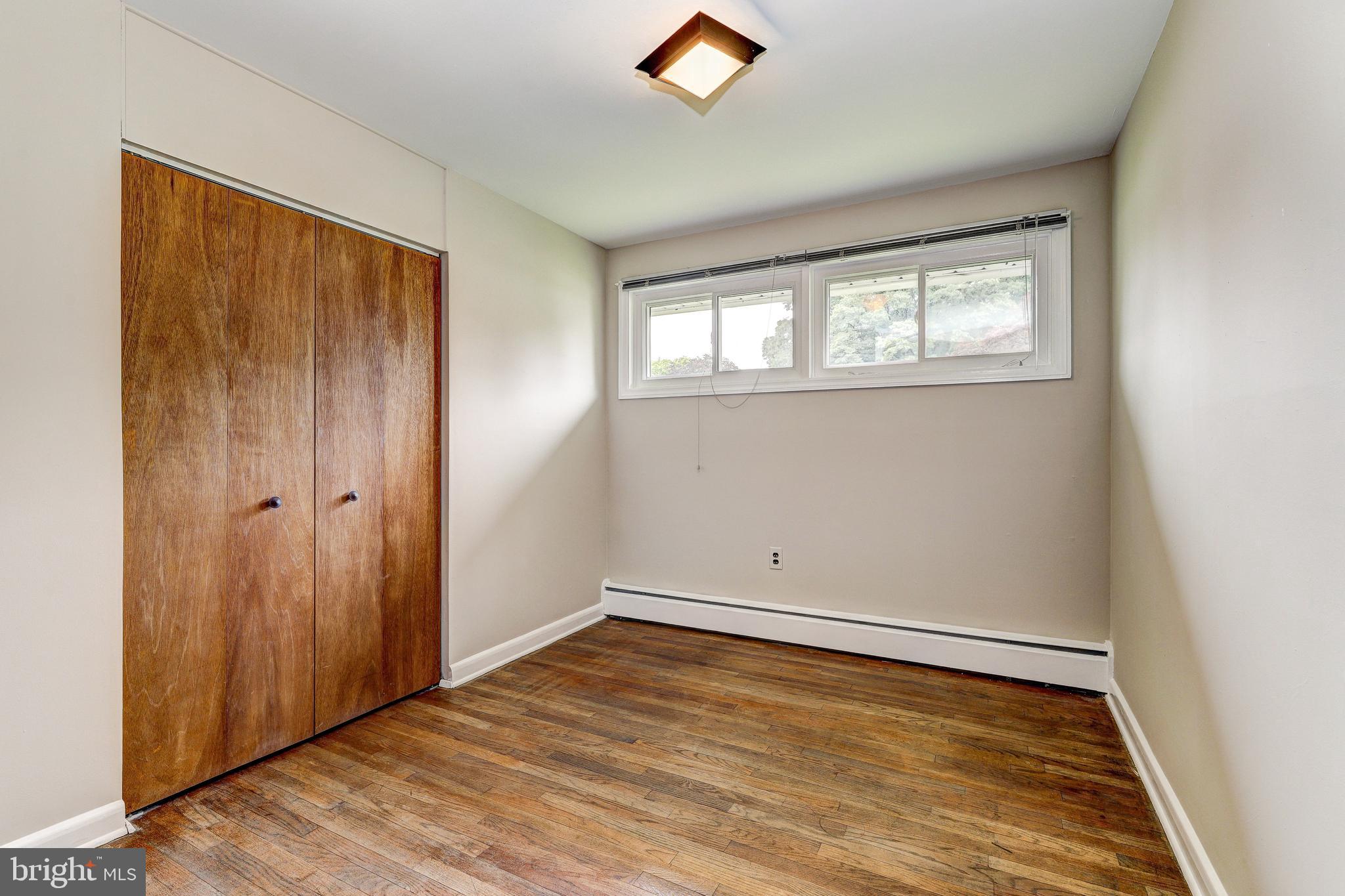 7500 Rocksham Drive Towson, MD 21286 - Photo 14 of 26 an empty room with wooden floor and windows