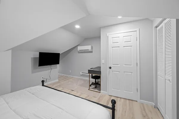 a bedroom with furniture and a window