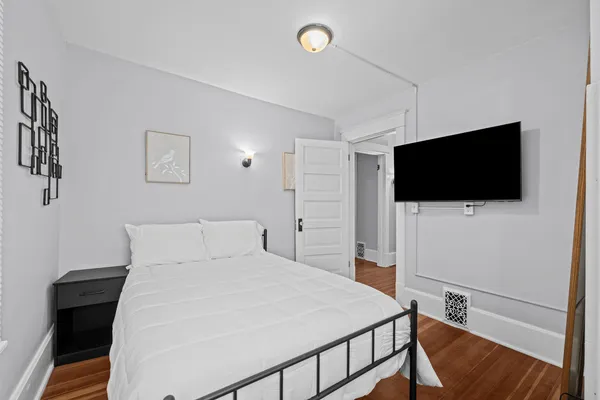 a bedroom with a bed and a flat screen tv