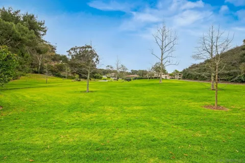a view of a lake with houses in the back