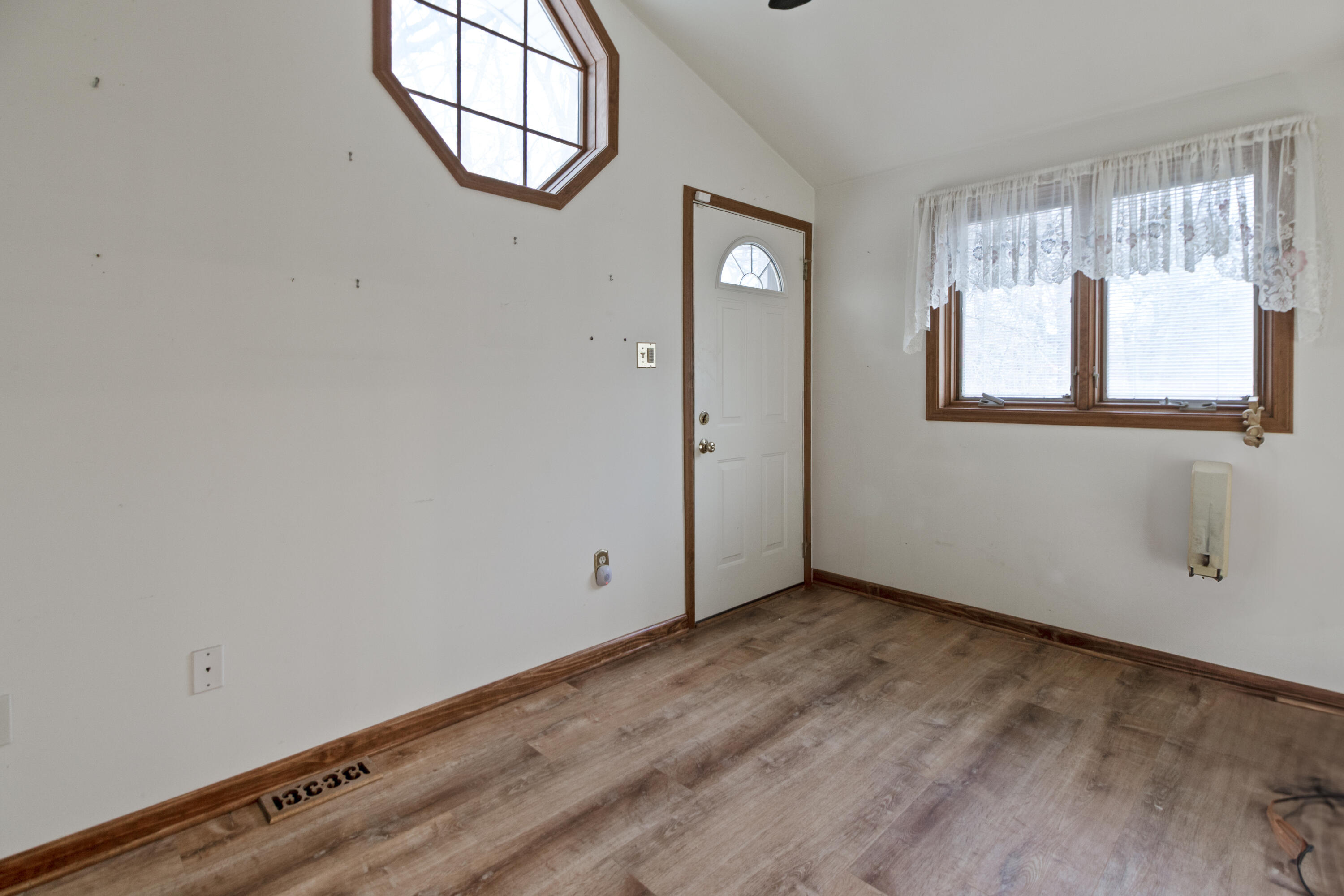 6610 East 3rd Avenue Gary, IN 46403 - Photo 11 of 24 an empty room with wooden floor and windows
