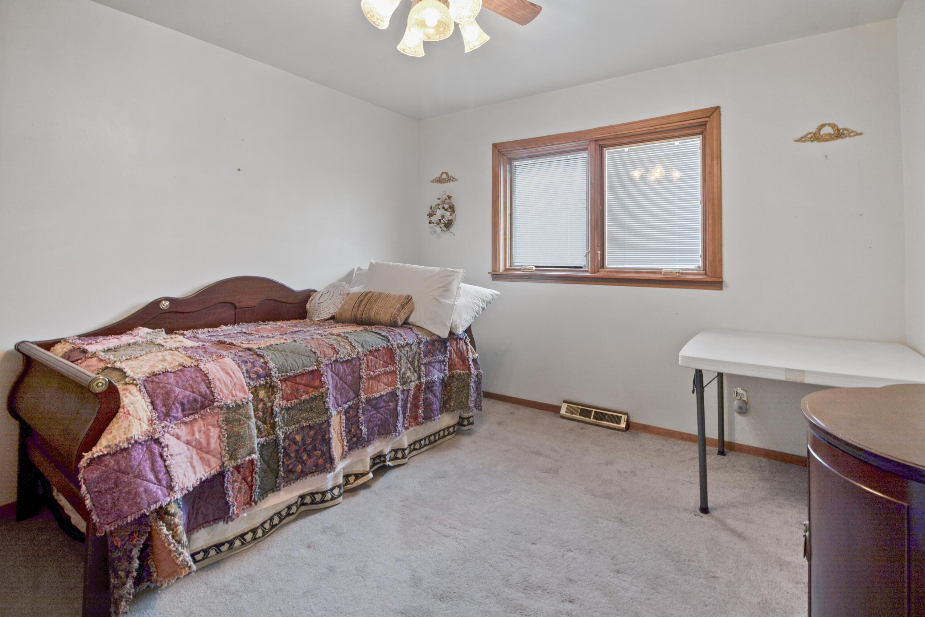 6610 East 3rd Avenue Gary, IN 46403 - Photo 14 of 24 a bedroom with a bed and a chandelier