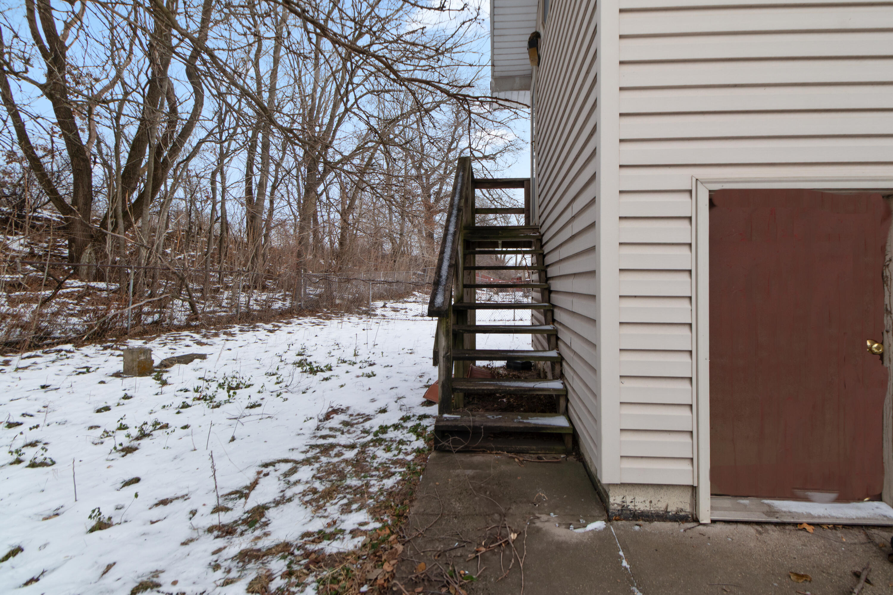6610 East 3rd Avenue Gary, IN 46403 - Photo 22 of 24 a view of a yard with snow on the wall