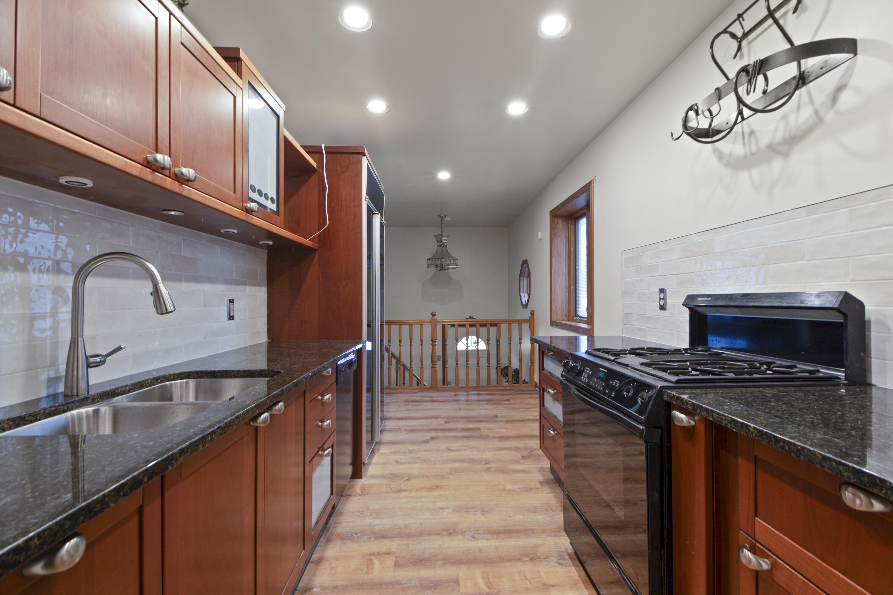6610 East 3rd Avenue Gary, IN 46403 - Photo 6 of 24 a kitchen with granite countertop stainless steel appliances and a sink