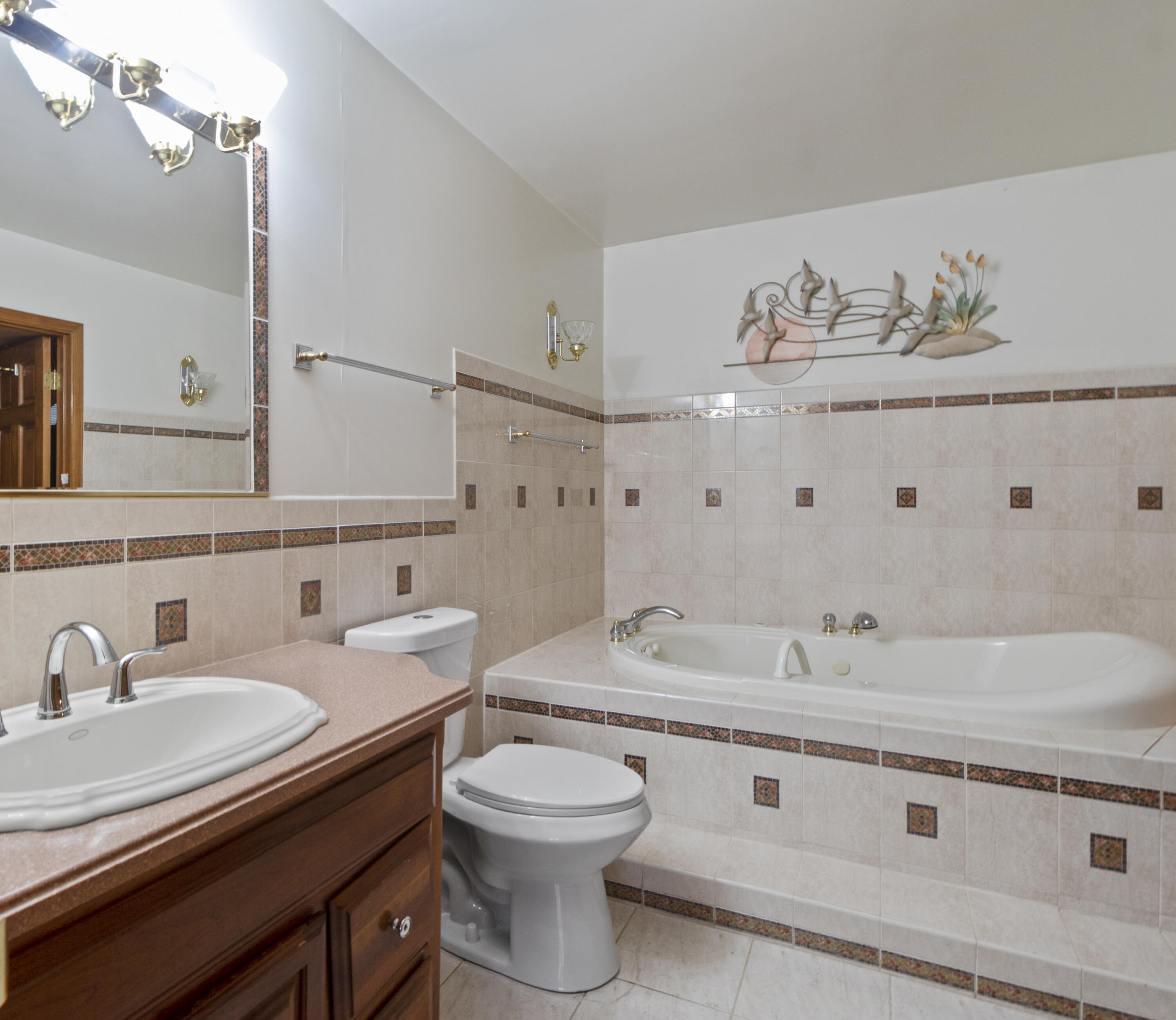 6610 East 3rd Avenue Gary, IN 46403 - Photo 8 of 24 a bathroom with a granite countertop double vanity sink and a mirror