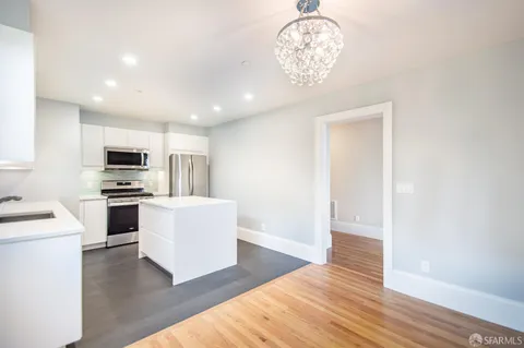 a view of a room with wooden floor and window