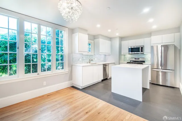 a view of a room with wooden floor and a large window
