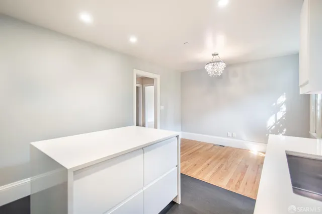 a living room with furniture a dining table and a large window