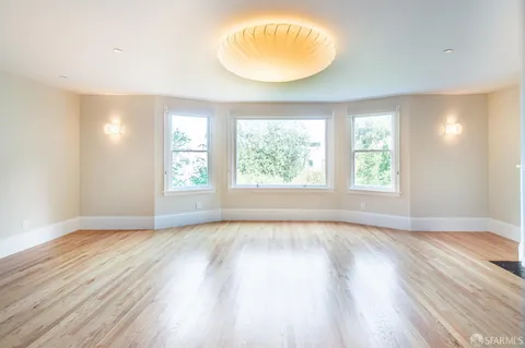 a living room with furniture a window and a table