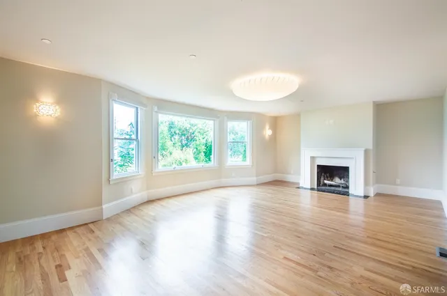 a living room with furniture a table and a large window