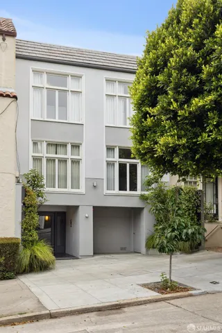 a view of a patio with table and chairs and potted plants