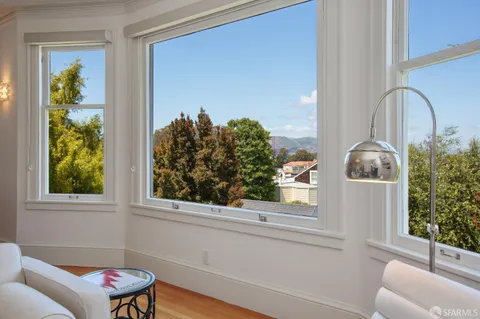 a bedroom with two beds and painting on the wall