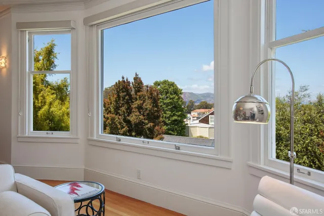 a bedroom with two beds and painting on the wall