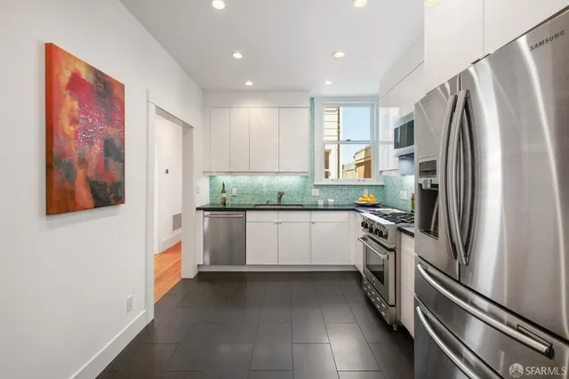 a bathroom with a granite countertop sink mirror and a shower