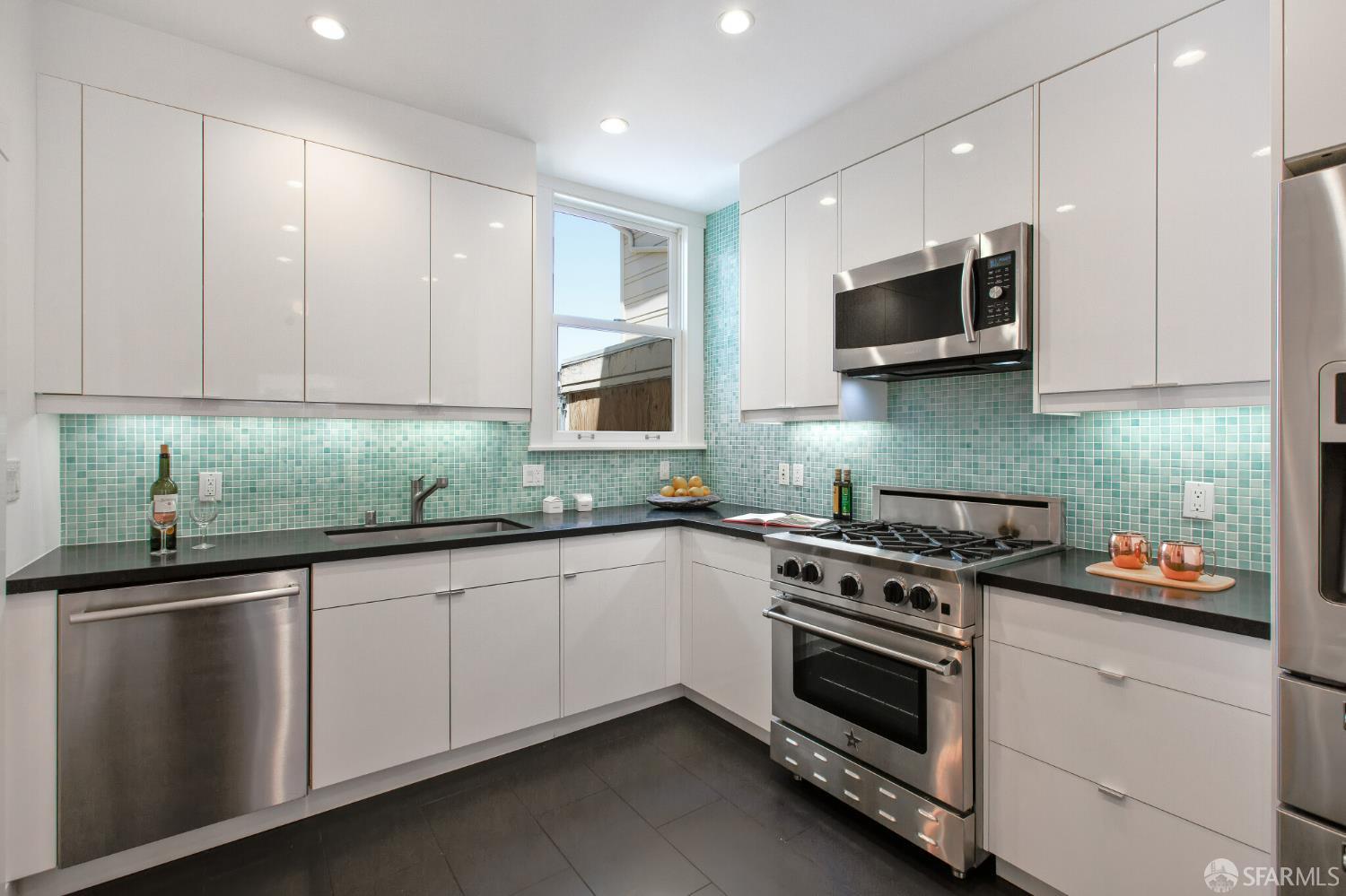 2740 Union Street San Francisco, CA 94123 - Photo 48 of 87 a kitchen with stainless steel appliances granite countertop a sink and a stove top oven
