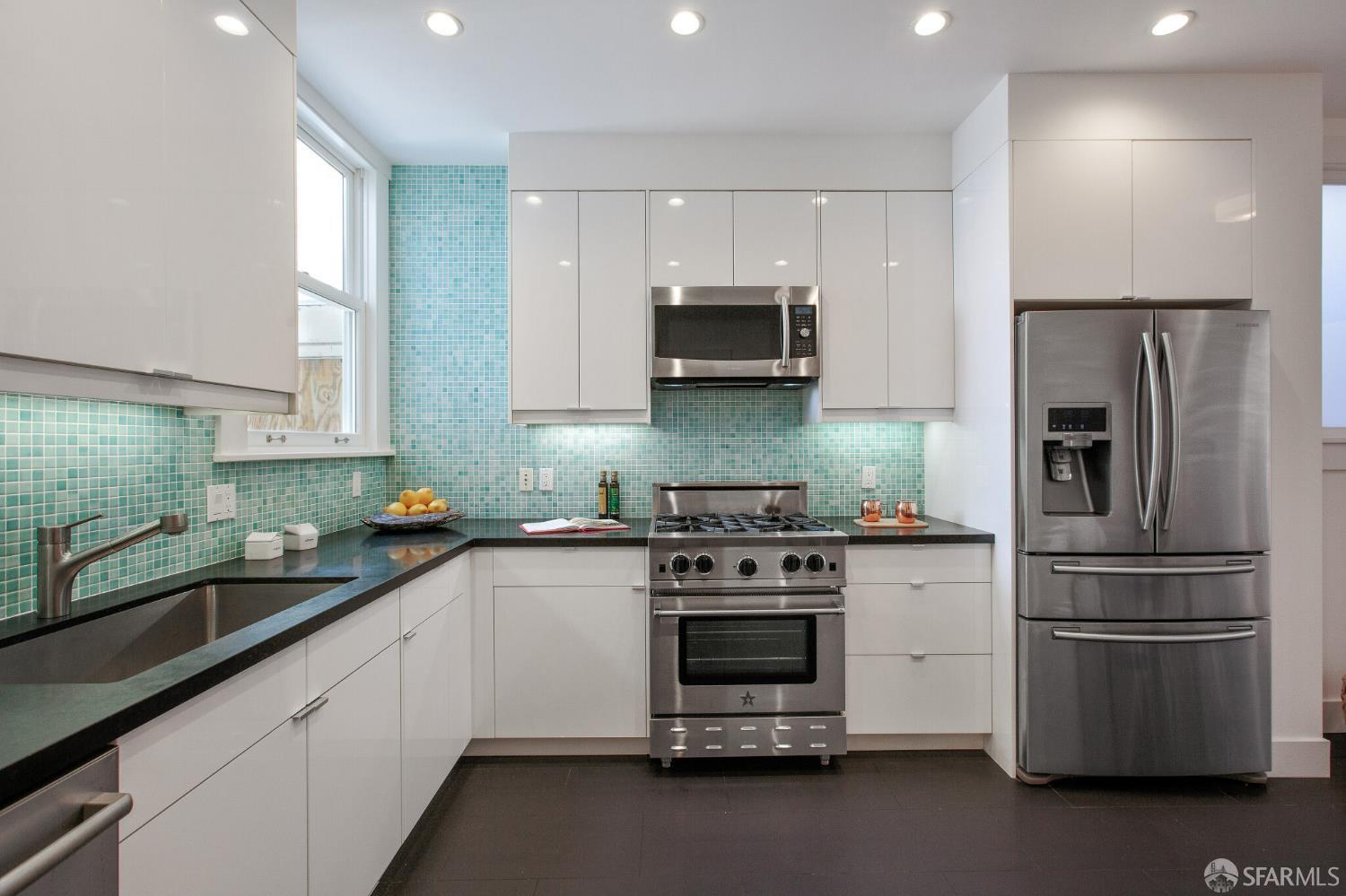 2740 Union Street San Francisco, CA 94123 - Photo 49 of 87 a kitchen with stainless steel appliances a sink a stove a microwave and cabinets