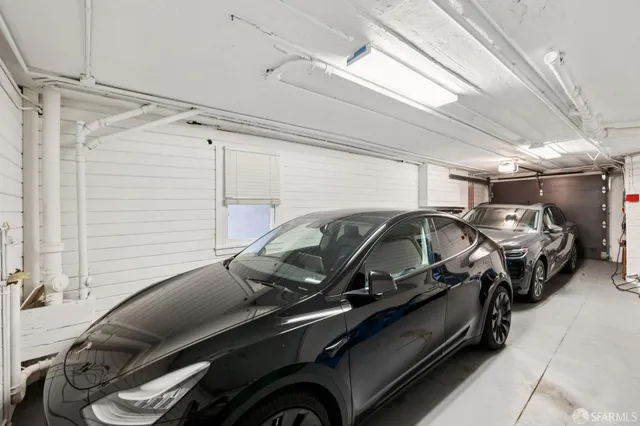 a view of storage and utility room with wooden floor