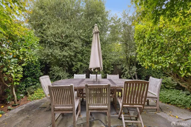 a view of an empty room with window and fire place