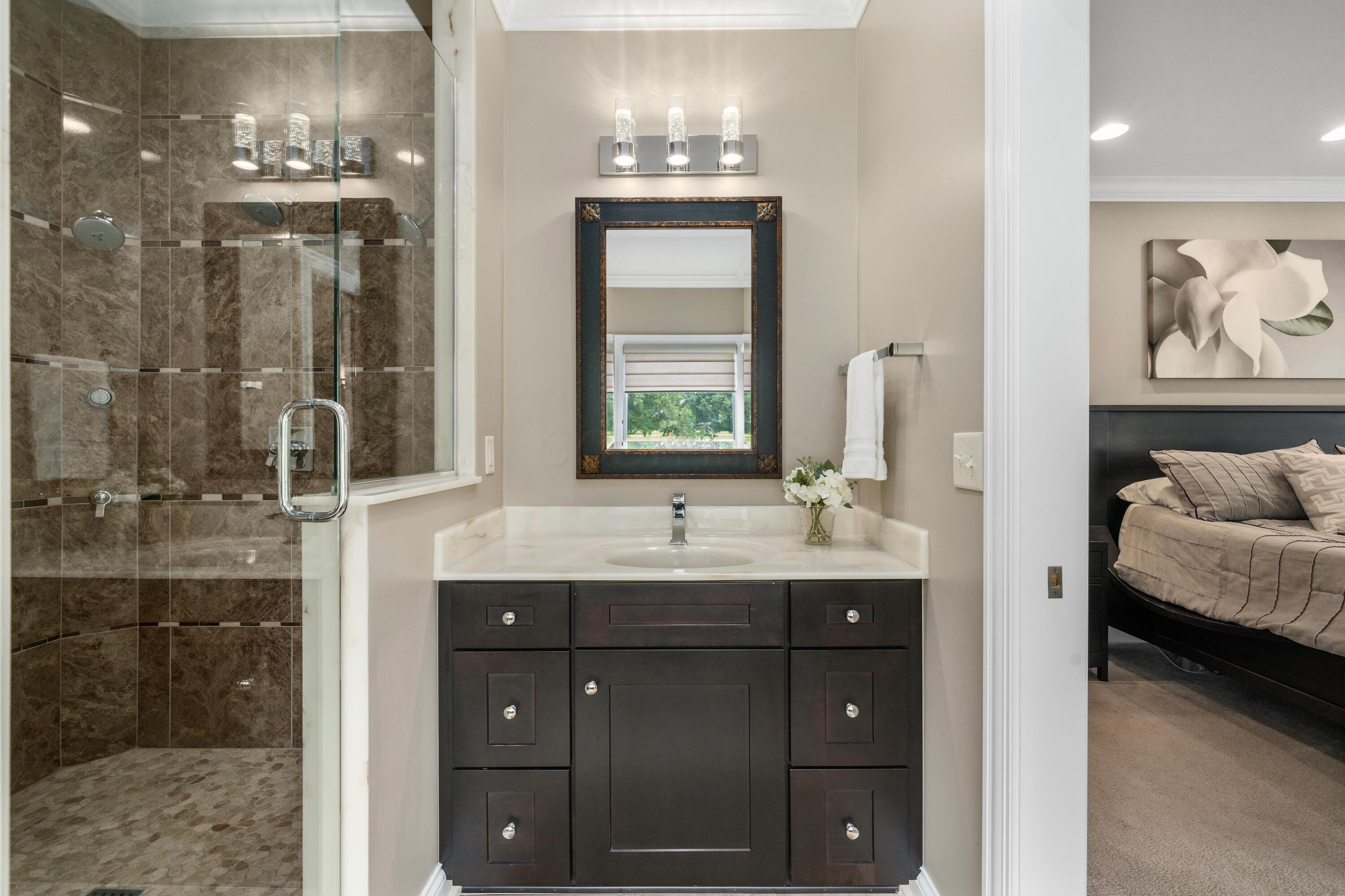 4640 Maynard Road Delaware, OH 43015 - Photo 36 of 91 Bathroom vanity with a light-colored countertop, undermount sink, and dark wood-finish cabinetry